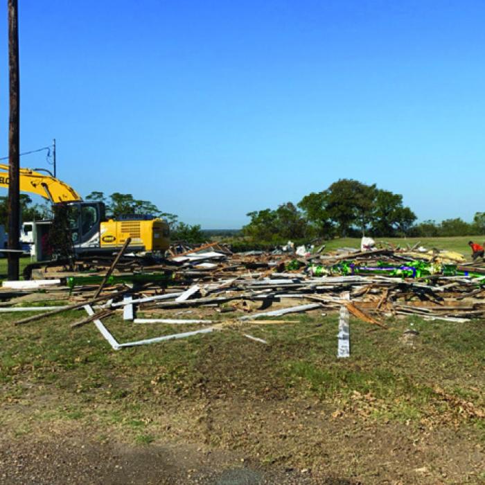 The old German Czech Mart came down at the Fairgrounds Tuesday morning, Oct. 9. Workers removed the tin from the roof last week. Joe Rogers Dozer Service was on site Tuesday morning to demolish the rest of the structure.
