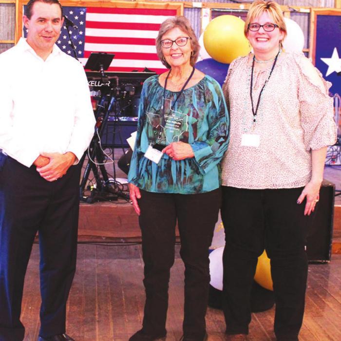 Linda Mattocks, center, was among the agents honored at a June 4 banquet hosted by Hermann Sons Life for its top producers. Presenting Linda with her award were President and CEO Eugene Zollinger and Vice President of Sales Robin Czarnek.