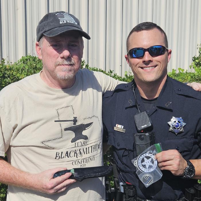 La Grange Patrol Officer Mitchell Maxwell (right) will be named an Officer of the Year by The 100 Club for saving the life of fellow officer Kevin Currington (left). Currington, who is also a blacksmith, is pictured here presenting Maxwell with a knife he made earlier this year