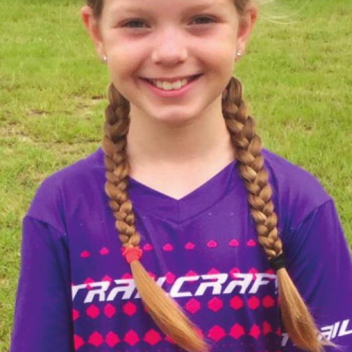 Elora Walkup, who is ten years old, was enthusiastically awaiting her start time for the mountain bike race.