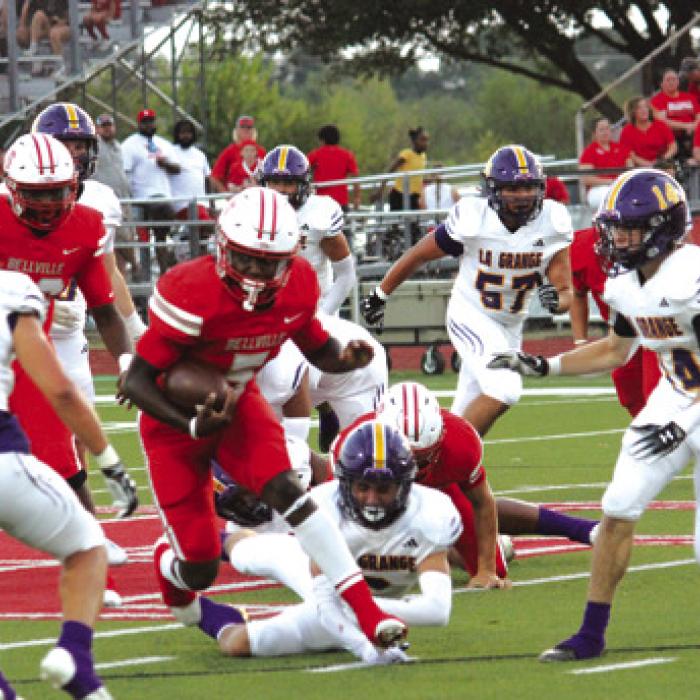 La Grange defensive players converge on a Bellville ballcarrier Friday.