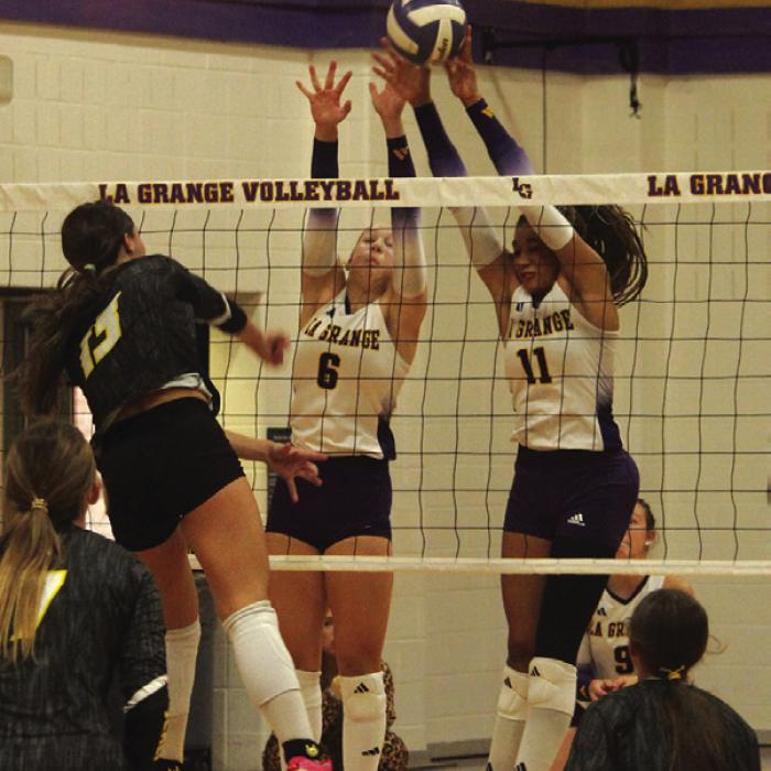 La Grange’s Gabby Hollek, center and Brion Williams, right, jump to try to block this Sealy hit Friday. Photo by Jeff Wick