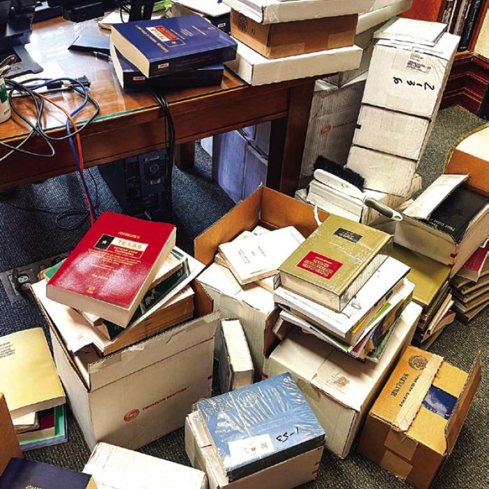 A jumble of mostly unopened or unwrapped boxes of law books (some dating back years) fill the floor of the county Law Library in the courthouse when we visited Friday. Photo by Andy Behlen