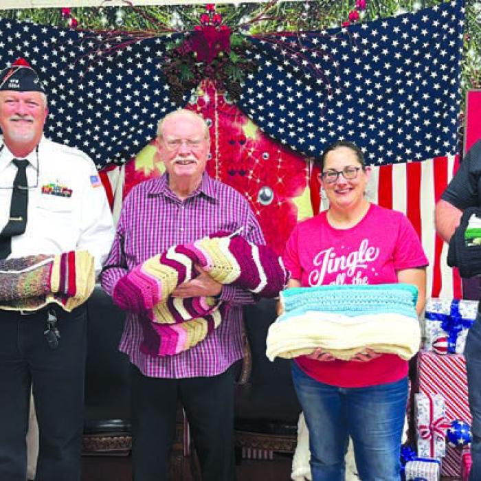 From left, Donna Wessels, donor of the crocheted lap afghans, with Veteran winners Richard Gray, Bill Asbill, Erika Fischbach, and Lance Nickel.