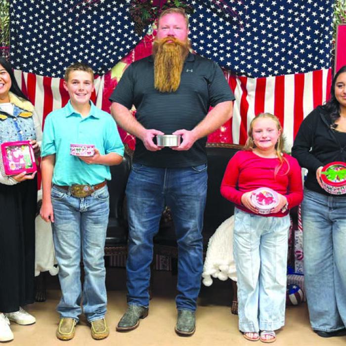 On left and right, VFW Auxiliary President Marilyn Kothmann and Chaplain Mary Gray, who presented the Winners of the “guess the number of candies in the tins” game: Kim Mamaril, Teague Weinert, Lance Nickel, Libby Robertson, and Elizabeth Castillo.