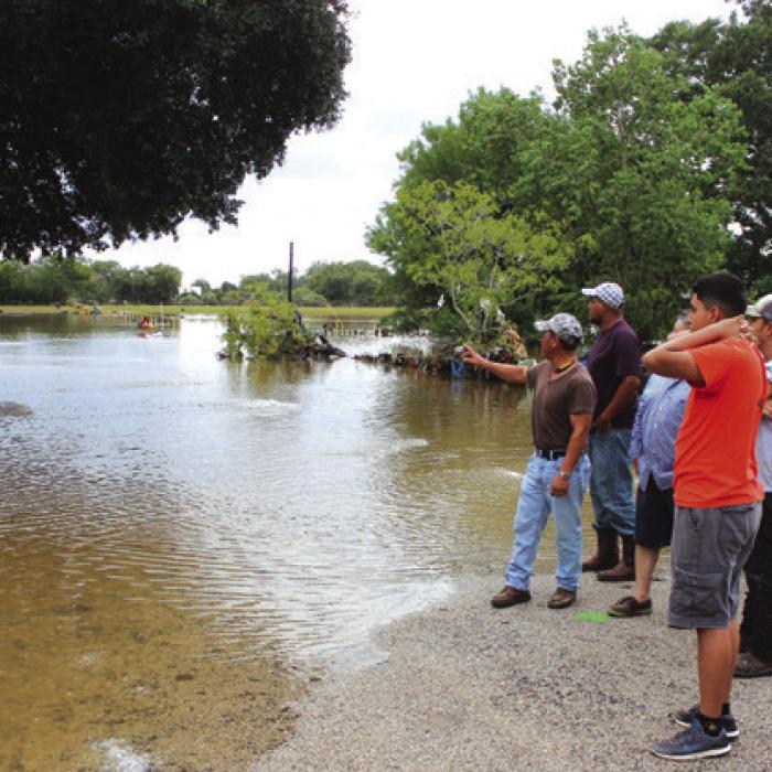 La Grange residents look into their flooded neighborhood from higher ground five years ago.