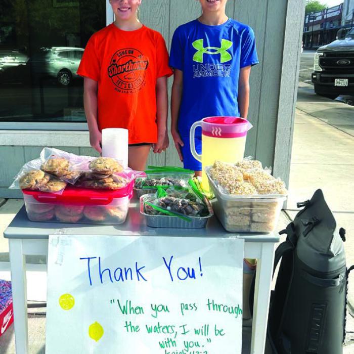 Kase Bubela, 11, right, and his cousin Chandler Bubela, 9, left, spent two days last week in front of Anytime Fitness on North Main St. in Schulenburg selling treats and lemonade to raise money to help the people devastated by the flooding in the Hill Country on July 4. The first day the Bubelas made close to $500, said their grandfather, Kenneth Kocurek, who made a bunch of rice krispy treats to restock their stand for Day 2. In all, the kids raised over $1,100. Photo by Kenneth Kocurek