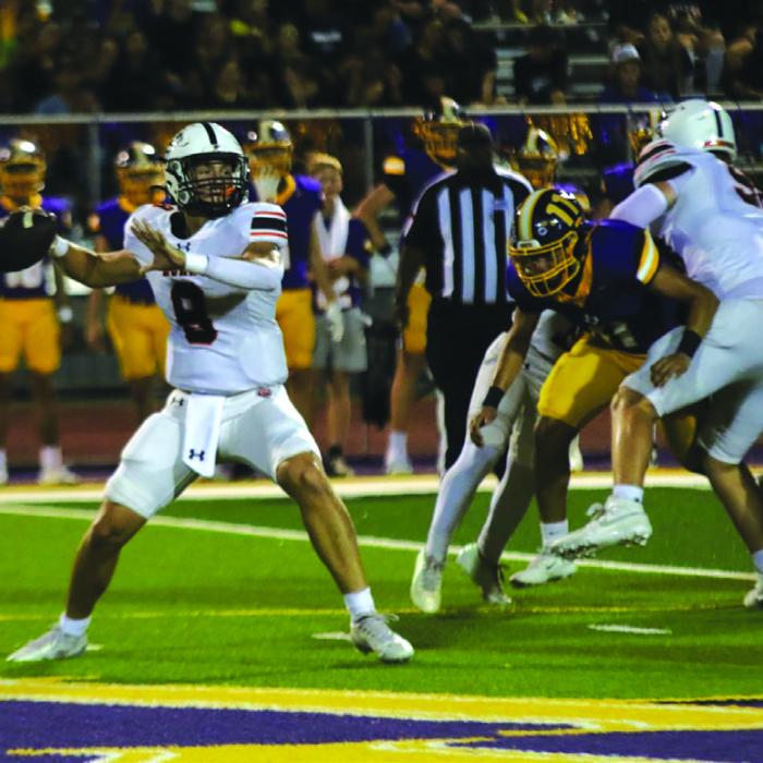 Schulenburg quarterback Owen Brenek looks to make a pass Friday as a Weimar player tries to get through the Shorthorn line to apply pressure. Photo by Audrey Kristynik