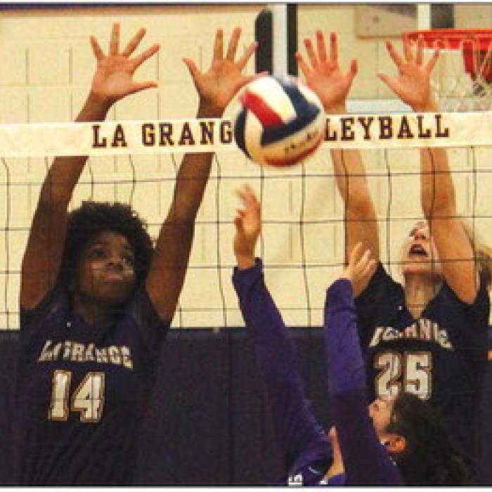 La Grange’s Tori Harold, left, and Kylie Trlicek, right, block a try by Austin Achieve in Friday’s victory. Photo by Jeff Wick