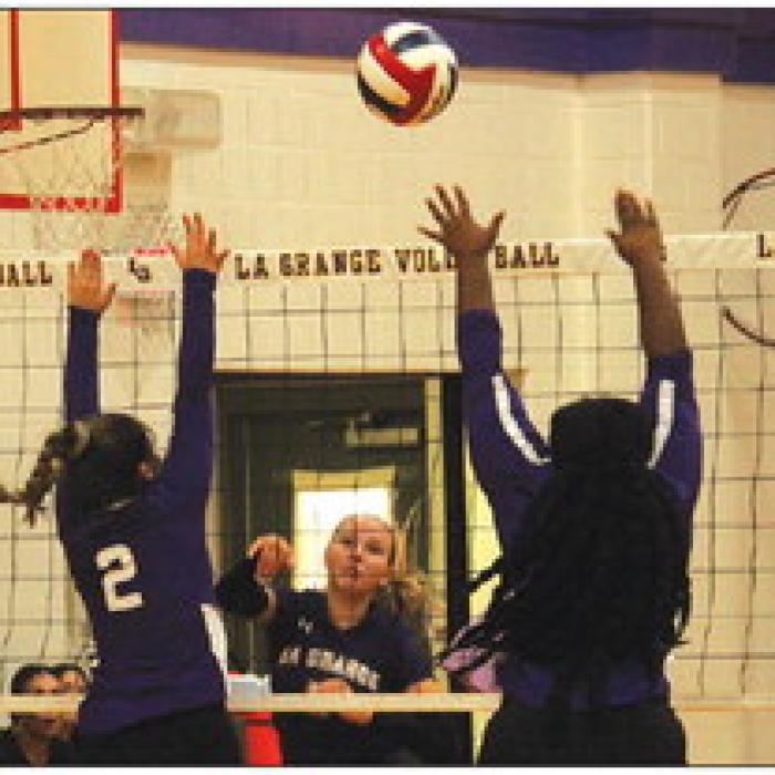 La Grange’s Jena Jobb watches as her hit goes between a pair of Austin Achieve blockers Friday. Photo by Jeff Wick Photos by Stephanie Steinhauser