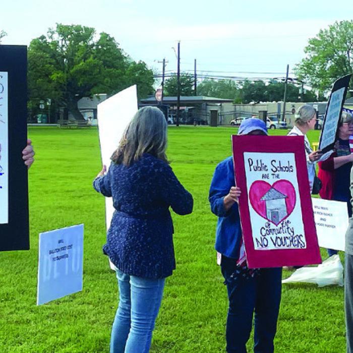 Protestors outside Governor Abbott’s event Tuesday. Photos by Andy Behlen