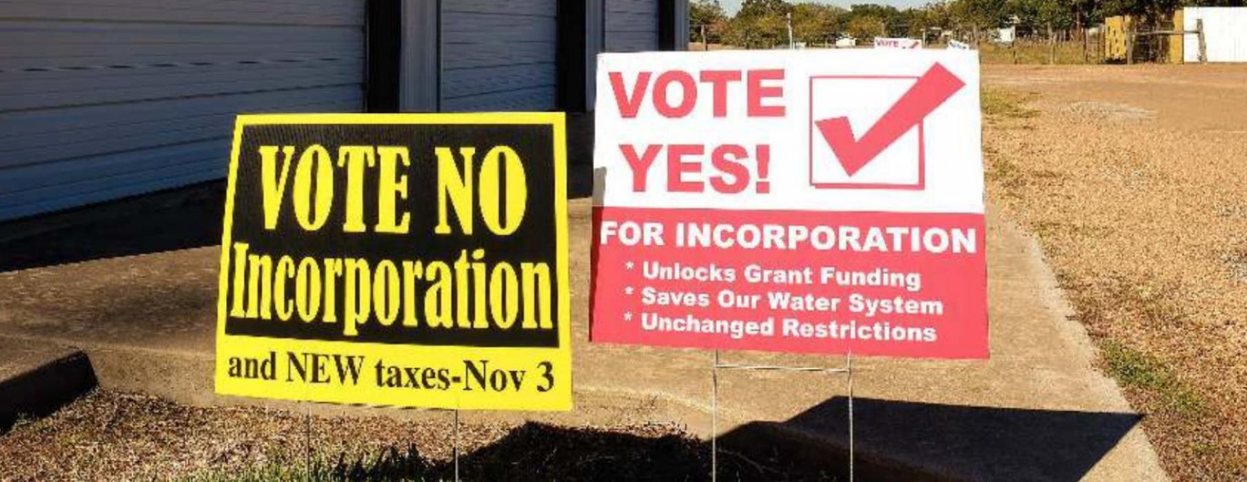 A pair of campaign signs for the Ellinger incorporation election stand outside the fire station in Ellinger. Resident approved the incorporation question by a vote of 76-44. Photo by Andy Behlen