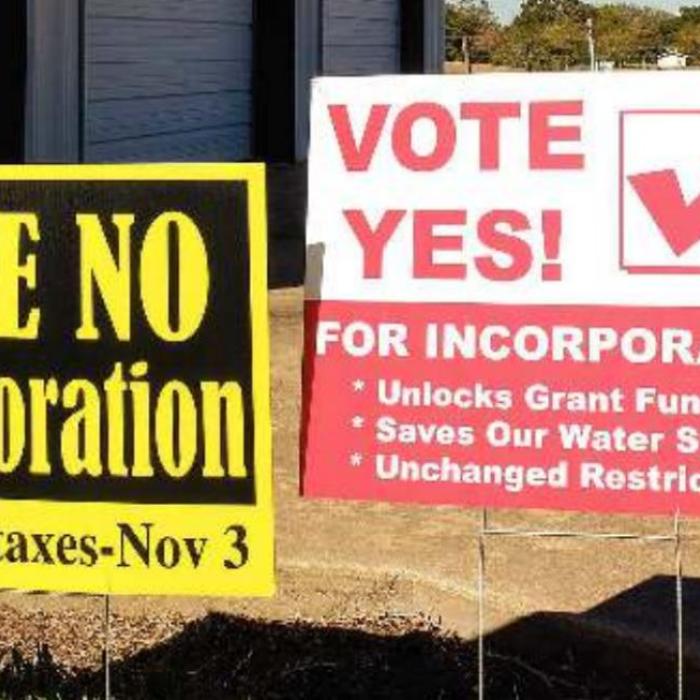 A pair of campaign signs for the Ellinger incorporation election stand outside the fire station in Ellinger. Resident approved the incorporation question by a vote of 76-44. Photo by Andy Behlen