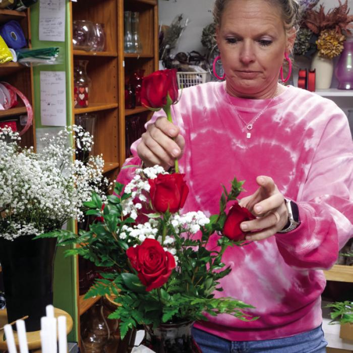 Local flower shops were abounding with roses, baby’s breath and blossomy fragrance this week as florists geared up for their busiest time of the year – Valentine’s Day. Pictured above working on arrangements are Brooke Smith (left) of Bloomin’ Junction and Jennifer Zaruba (right) of Frogs and Flamingos. Photos by Andy Behlen