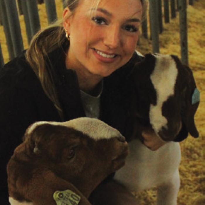 Hope Michalke of La Grange smiles with her goats before Friday’s show.