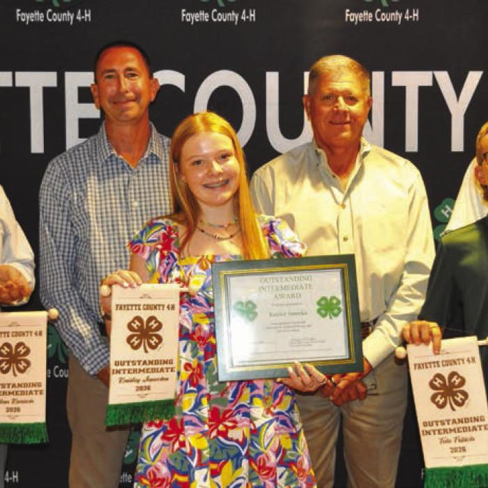 Outstanding Intermediates, front from left: Rilan Karisch, Kaisley Janecka, and Tate Fritsch; back row: Commissioner Jason McBroom, Commissioner Harvey Berckenhoff, and Commissioner Clint Sternadel, presenting awards.