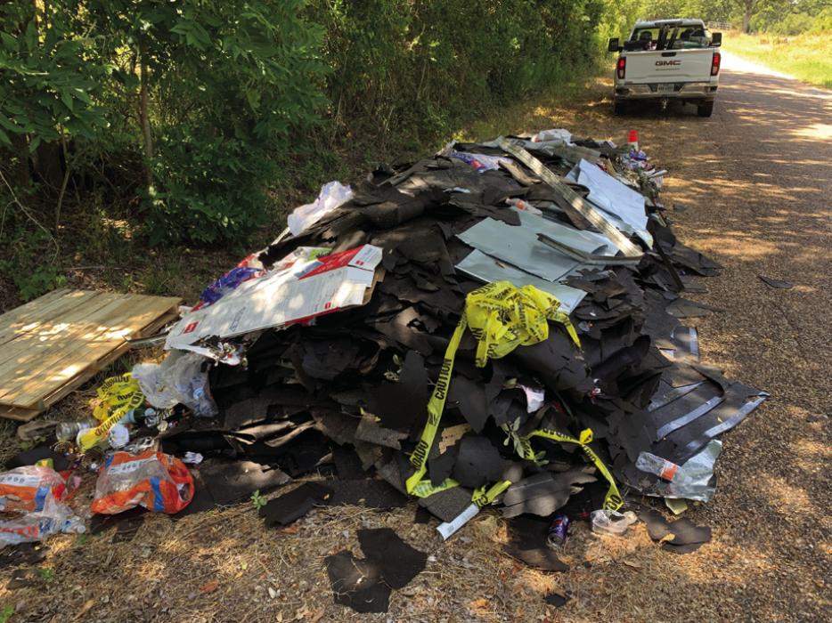 An out-of-town contractor allegedly dumped this pile of roof shingles and construction debris on Owl Creek Rd. last week.
