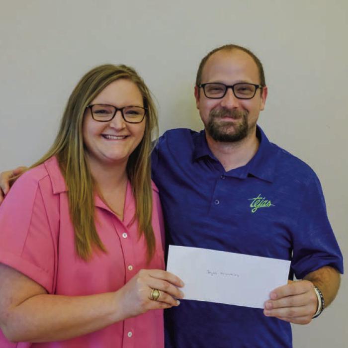 Tejas Ministries received a $2,000 grant from the Texas Women’s League. Pictured are Kristen Vandever of TWL (left) and Zach Lineback of Tejas Ministries.
