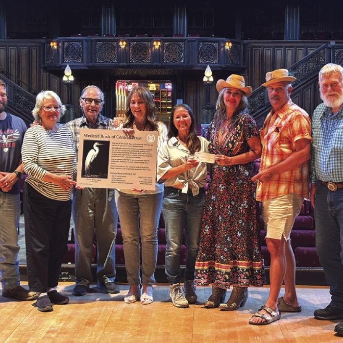 Accepting the check on the Concert Hall stage are RTFI Staff members Chris Johnson, Pat Johnson, James Dick - Founder and Artistic Director; artist Elen Hart, RTFI Horticulturalist Julie Johnson, Crown Bar owners Beth Weishuhn, Andy Johnson, and Larry Weishuhn