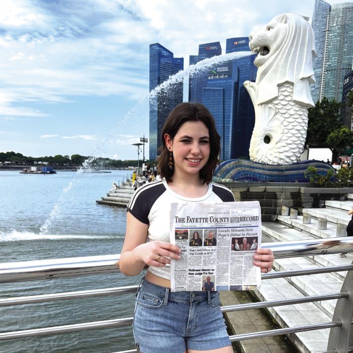 Jane Griffith, 16, travelled to Singapore, Malaysia, Thailand and Japan this summer, spending six weeks in Singapore in a language immersion program studying Mandarin Chinese. She brought the Fayette County Record with her. She chose the issue reporting encounters with the new pope, as his selection brought her a lot of joy. Here she is posed at the famous Merlion statue in Singapore, a mythical creature that is a symbol of the city.