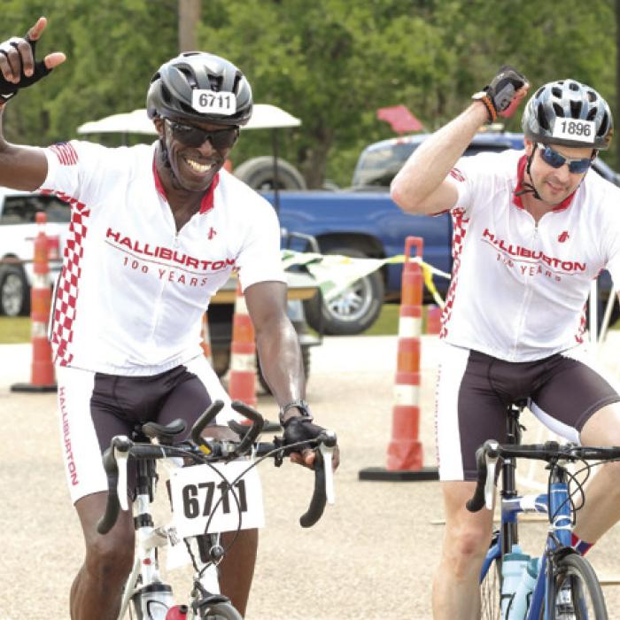 Cyclists celebrate at they arrive at the midway point of the MS 150 ride in La Grange.