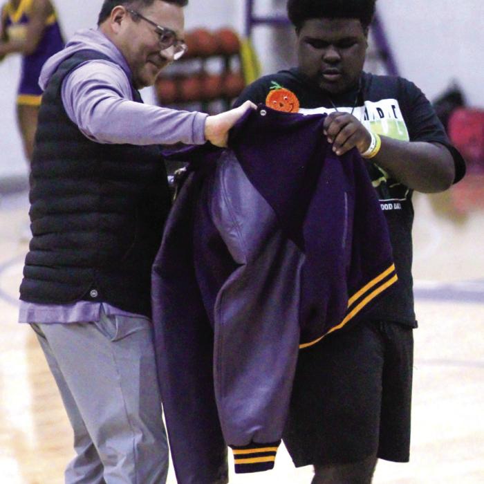La Grange High School student Curtis Smith, right, was presented a special letterman jacket by principal John Pineda, left, during a pep rally last week. Photo by Lila Glaiser, Leopard Spots Yearbook