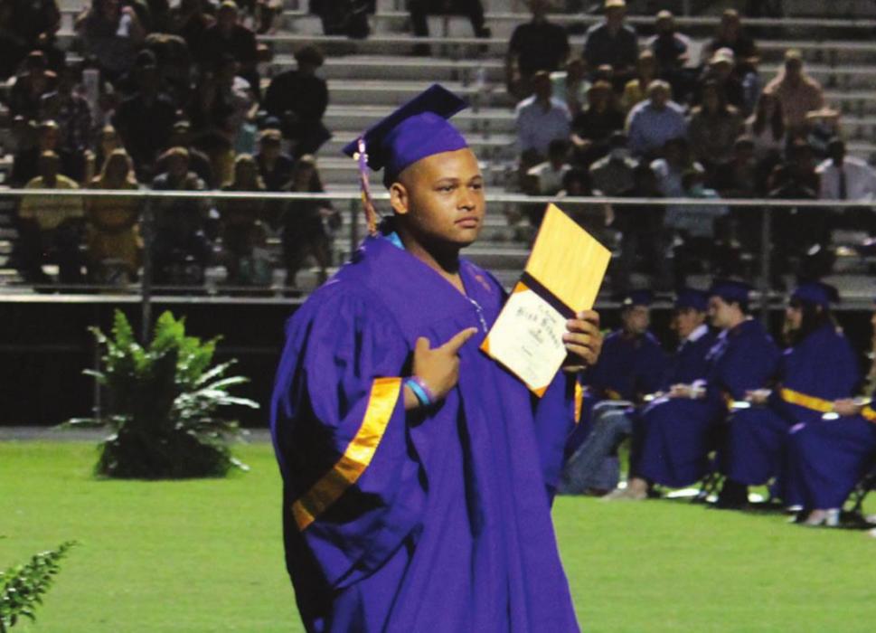 Tre Scott shows off his diploma as he walks back to his seat during Thursday’s ceremony.Photo by Jeff Wick