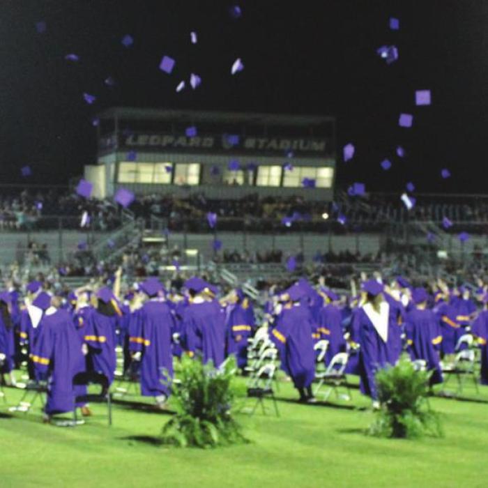 The seniors all had a spare graduation hat that they were allowed to toss at the conclusion of the ceremony but not retrieve because of coronavirus precautions.