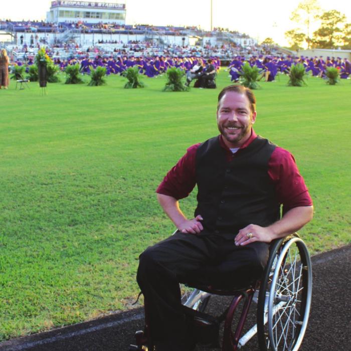 John Comstock, the graduation guest speaker poses for a photo prior to the start of Thursday’s ceremony. He was the last surviving student to be pulled out of the 1999 Texas A&amp;M bonfire collapse that killed 12 and injured 27 students.