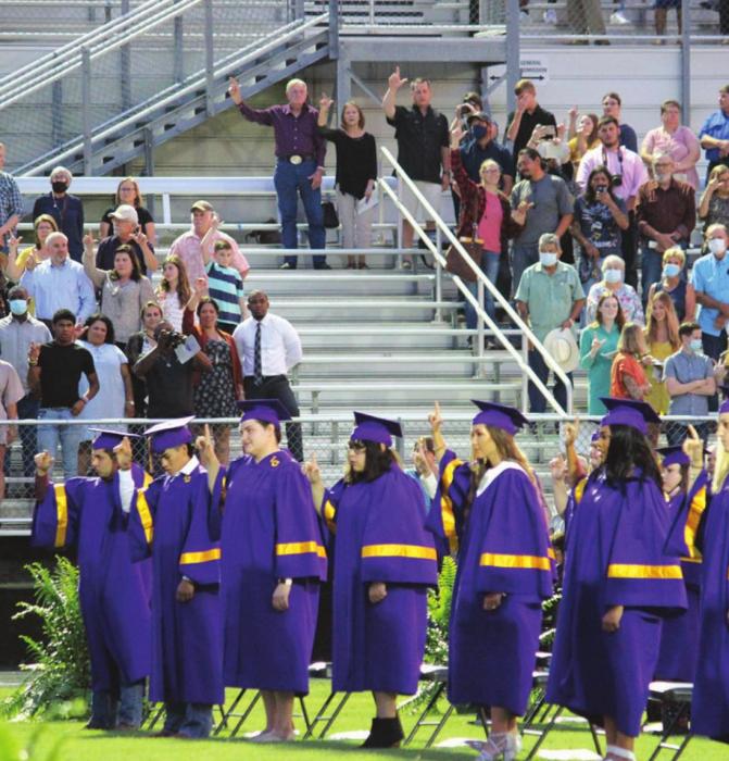 La Grange graduates sing the school song as attendees (groups of 10 or less for each grad were spaced apart) look on.