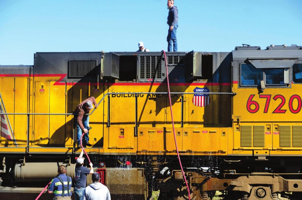 Schulenburg firefighters douse the inside of a Union Pacific train with water after it started smoking from an electrical malfunction Tuesday morning. Photo by Andy Behlen