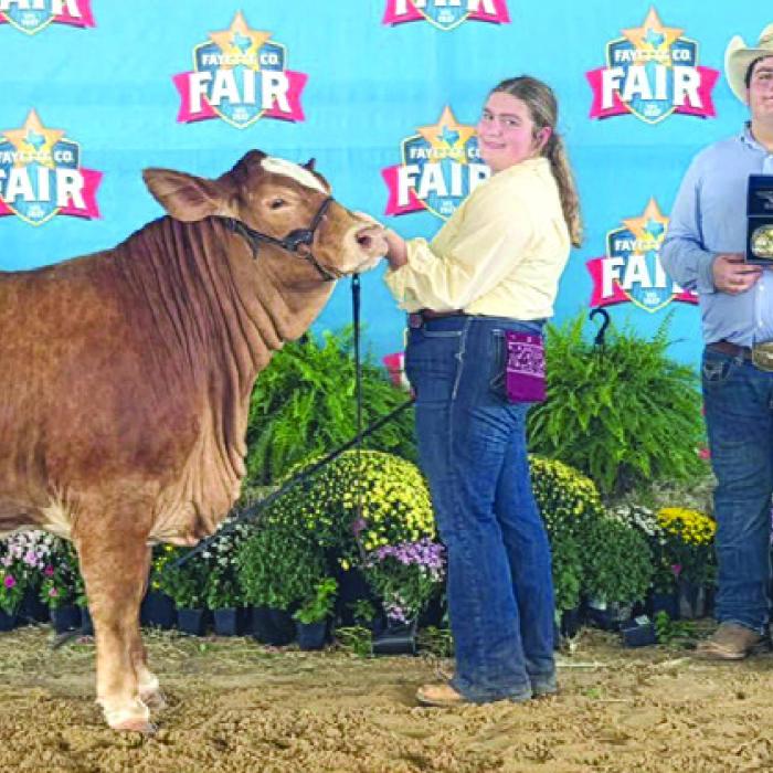 Grand Champion Heifer: Rheagan Karisch, Rilan Karisch, holding buckle, Carson and Aubrey Neumann, holding awards.