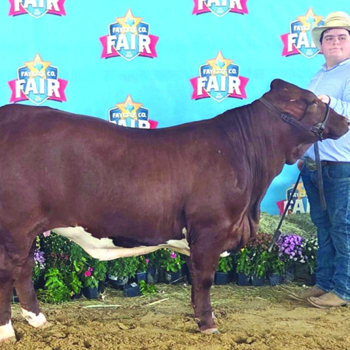 Intermediate Showmanship: Judge Aaron Wilson, Rilan Karisch and Rheagan Karisch, holding buckle.