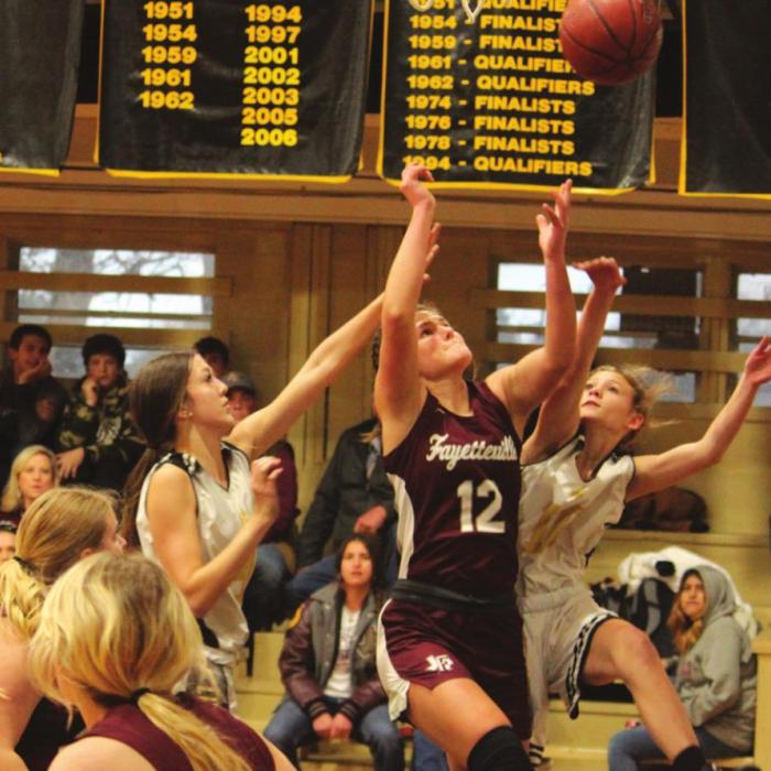 Fayetteville’s Kayme Schley goes up for a shot against the defense of RT-C’s Kennedy Flinn, left, and Jill Eilers, right.
