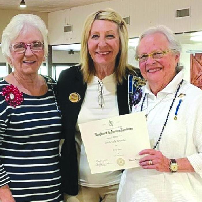 DAR Regent Carolyn Caflisch and Treasurer Jackie Head presented Sally Reynolds with her 50-year award.