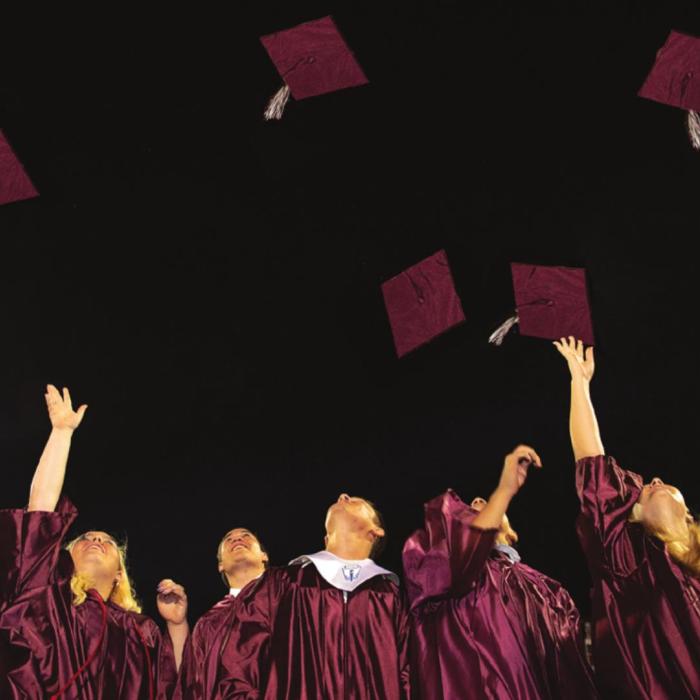 The Flatonia Class of 2020 tosses their hats into the air in celebration of completing a milestone in an unusual senior year. Photo by Stephanie Steinhauser
