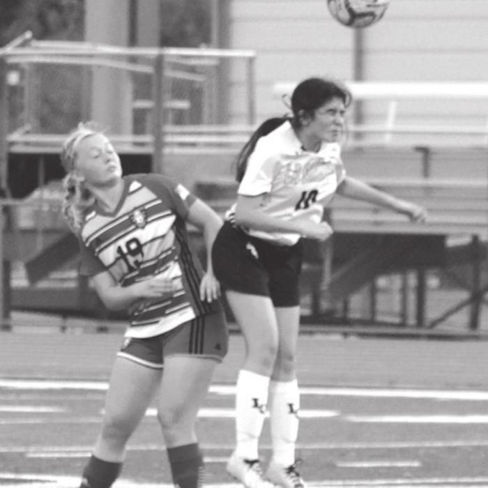 Yesenia Martinez heads a ball in Tuesday’s playoff game. Photos by Jeff Wick