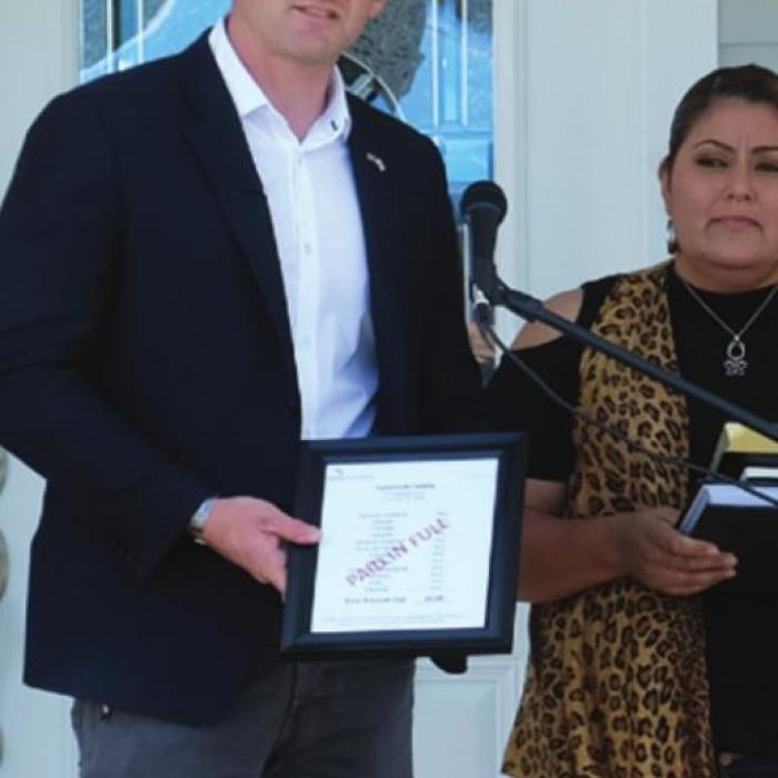 Edward Graham, son of Samaritan’s Purse founder Franklin Graham and grandson of the famous evangelist Billy Graham, handed Francisca Castaneda a bill for the costs of construction with a big stamp across the front that read “Paid in Full.”