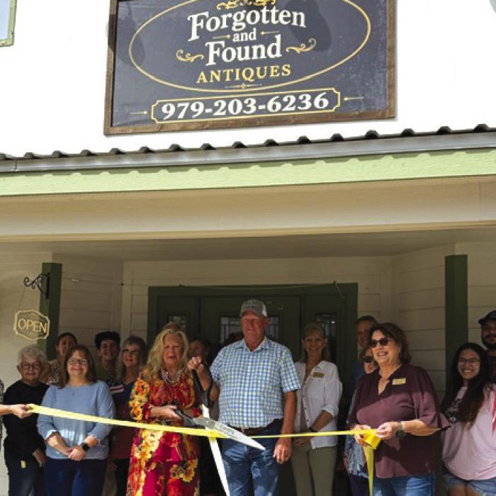Aribbon cutting for the new antique shop in Carmine, Forgotten and Found Antiques was held Oct. 3 hosted by the Carmine Chamber of Commerce. Pictured are owners Christine and Stephen Rosenbaum (center.) Diane Tovey and Marlene Waak are holding the ribbon. Other members of the Carmine Chamber of Commerce are pictured in the background.