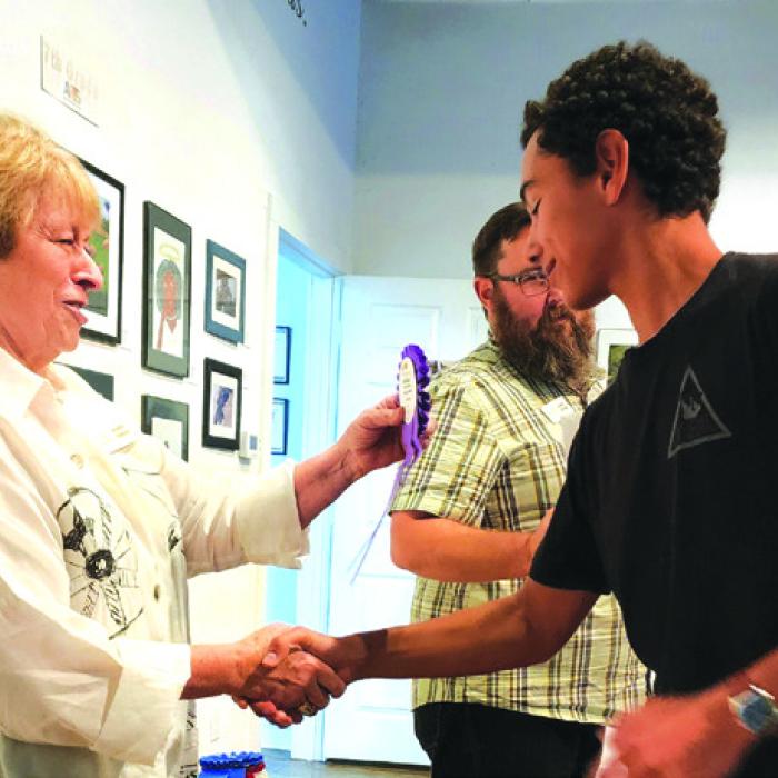 Karen Vernon, ARTS Executive Director, congratulating Phoenix Kooper, 2022 Best of Show Winner.