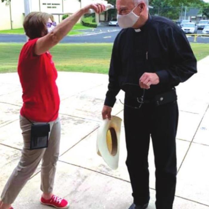 Even Father Steve Sauser, from Fayetteville and Ellinger, had his temperature checked when he came by the school Thursday.