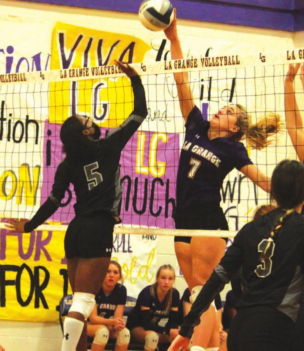 La Grange’s Riley Youens out-leaps her Manor New Tech counterpart to spike this ball in Tuesday’s volleyball match. Photo by Jeff Wick