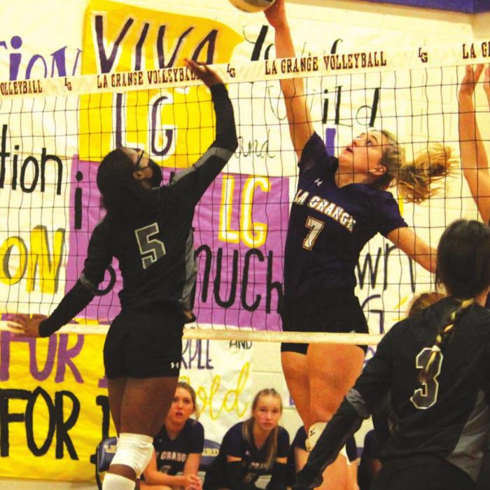 La Grange’s Riley Youens out-leaps her Manor New Tech counterpart to spike this ball in Tuesday’s volleyball match. Photo by Jeff Wick