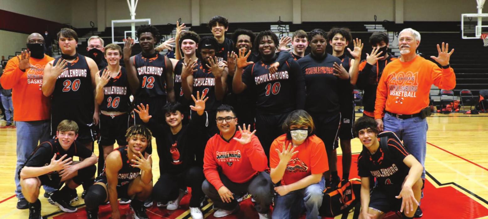 The members of the Schulenburg boys basketball team pose after their win Tuesday in San Antonio in the regional semifinals. They are all holding up five fingers because they are headed to the fifth round of the playoffs. Photo by Audrey Kristynik