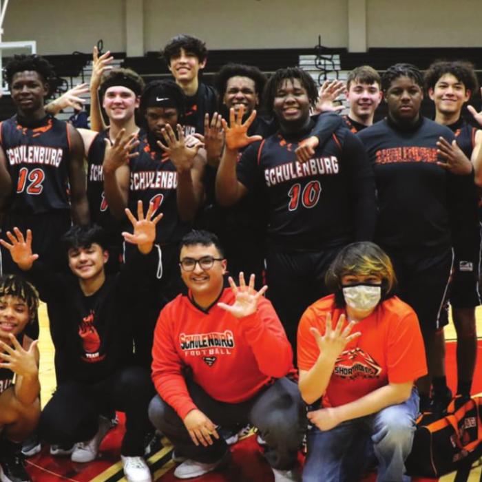 The members of the Schulenburg boys basketball team pose after their win Tuesday in San Antonio in the regional semifinals. They are all holding up five fingers because they are headed to the fifth round of the playoffs. Photo by Audrey Kristynik
