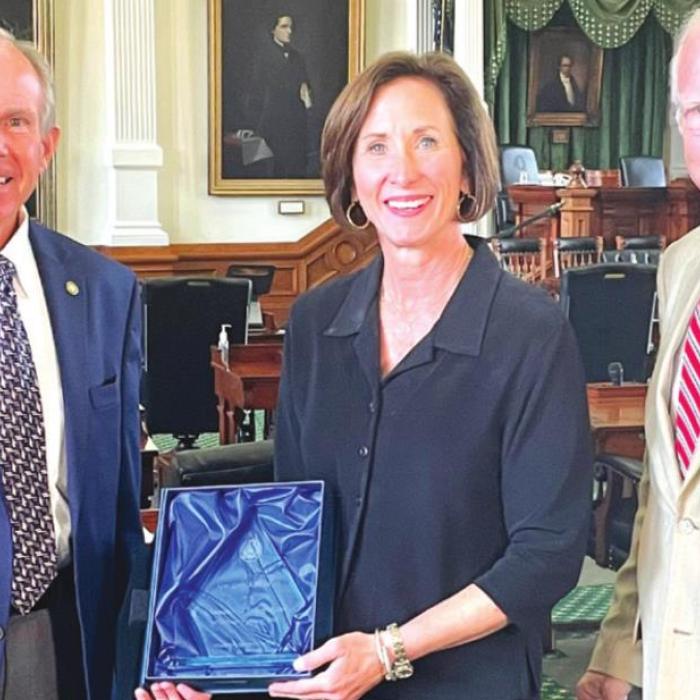 Sen. Lois Kolkhorst accepts the Champion of Transparency Award from Donnis Baggett, right, and Mike Hodges, left, of the Texas Press Association.