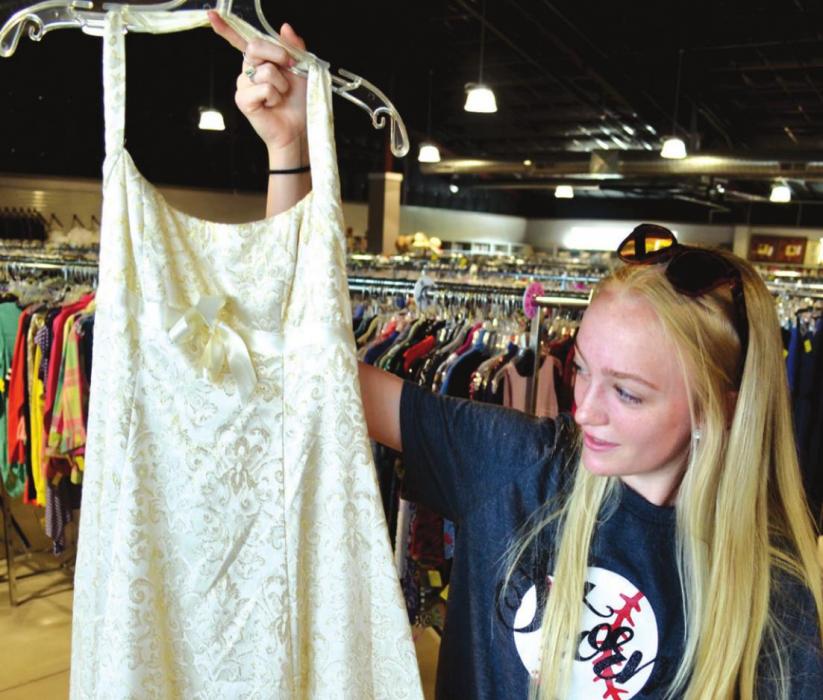 Abby Welker, a 10th grader at La Grange High School, admired a spangly wedding dress at Second Chance Emporium. The nonprofit secondhand everything store in La Grange has a trove of wedding dresses in stock – for either this June or sometime in the far-off future.