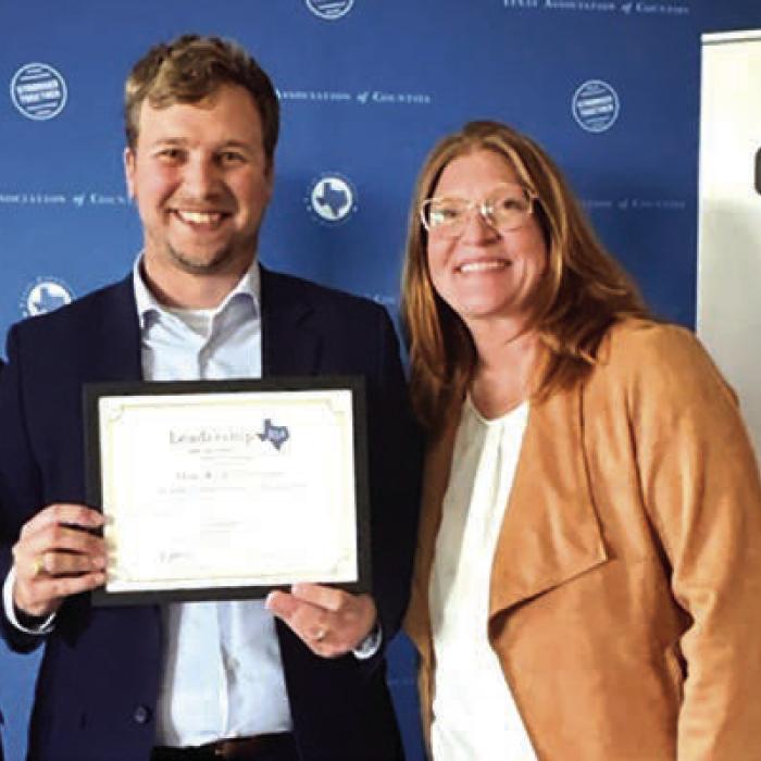Fayette County Justice of the Peace Pct. 1 Kyle Hartmann, center, successfully completed Leadership 254, a 14-month leadership program offered by the Texas Association of Counties (TAC).