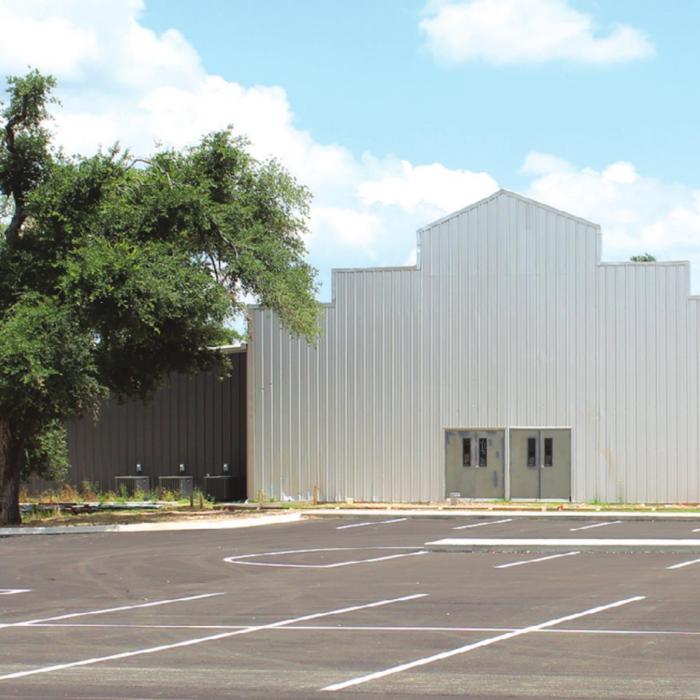 The worship center at the new First Baptist Church location is still under construction, but services will be held on the site for the first time this Sunday. Note the trees in the left of the photo, still snarled by damage from last year’s tornado. Photo by Jeff Wick