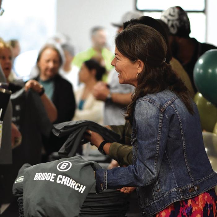 Many people were excited to get their Bridge Church t-shirts (pictured, Janet Jones).